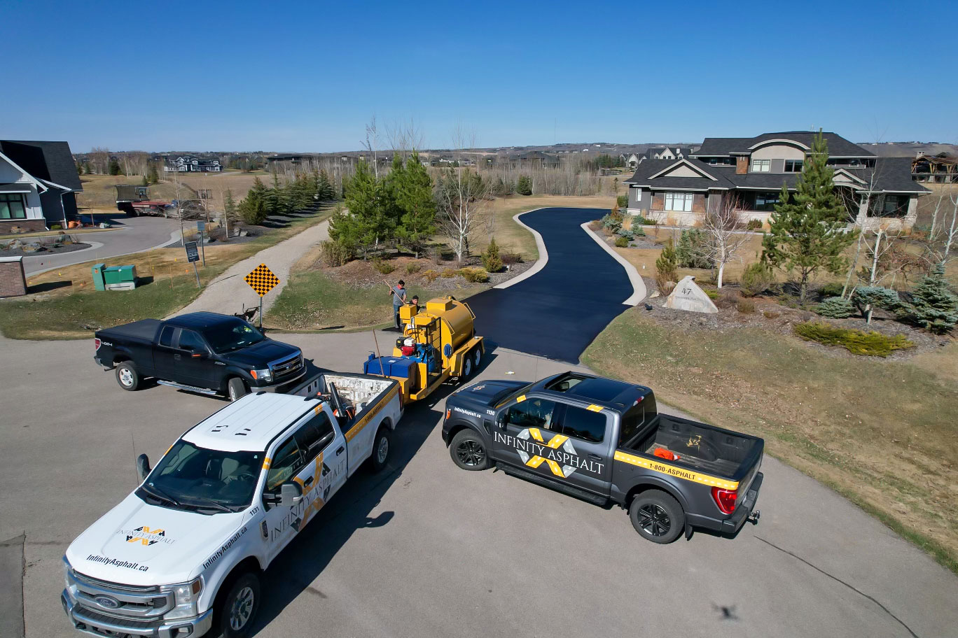 Infinity Asphalt crew paving driveway